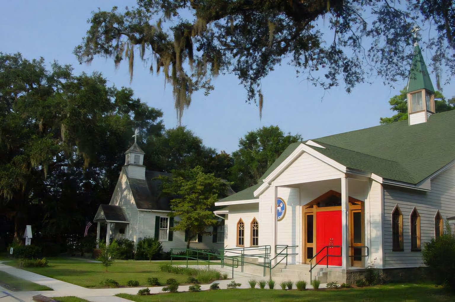 Christ Episcopal Church and historic chapel beneath oak trees